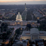 A photo of the U.S. Capitol and National Mall at night