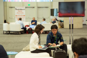 A woman and man having a private discussion at AGU's 2016 Fall Meeting