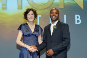 Photo of John Bosco Habarulema from the South African National Space Agency, 2016 recipient for the Africa Award for Research Excellence in Space Science shaking hands with AGU Executive Director and CEO Christine McEntee